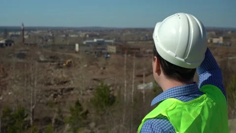 Engineer inspector inspects the territory for the future plant. Stock Footage 166996401