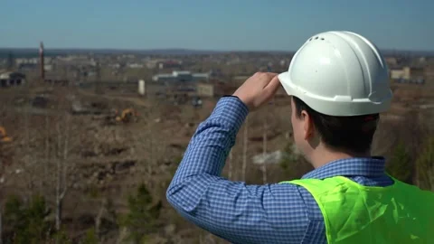 Engineer inspector inspects the territory for the future plant. Stock Footage 167551597