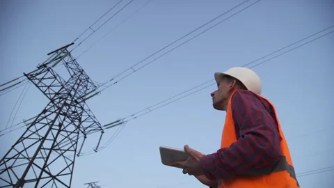 Engineer inspects a power line using data from electric sensors on a tablet. Stock Footage 139823982