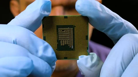 An engineer inspects a processor die for damage. Close-up, selective focus. Stock Footage 202268127