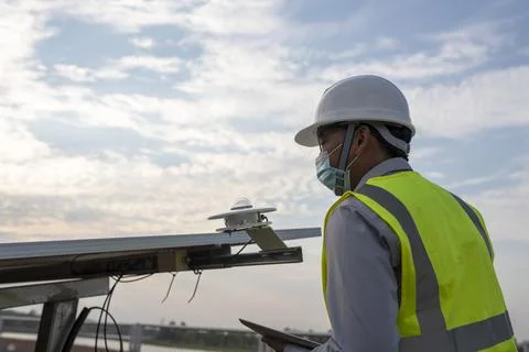 Engineer inspects pyranometer installation in solar farm to measure sunlight Stock Photos