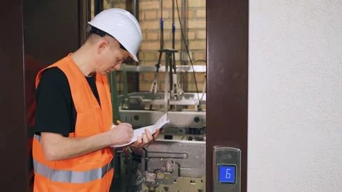 Engineer inspects quality of elevator parts, complex modern elevator equipment Video stock 266229762