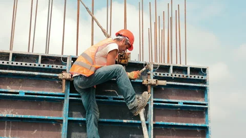 An engineer installs metal structures during the construction of a house Stock Footage 250383761