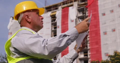 Engineer Job In a Construction Site Study Careful a Building Plan Stock Footage 102259338