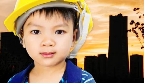 Engineer kid with safety hat on shadow city background Stock Photos