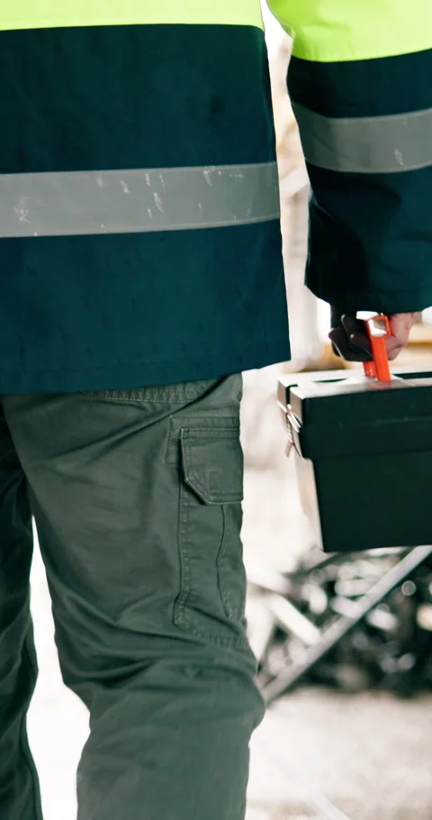 Engineer, labor and toolbox of man walking at construction site for renovation Stock Footage 340874107