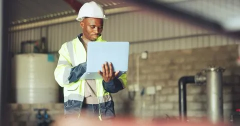 Engineer, laptop and black man in warehouse for hydraulic system, inspection and Stock Photos