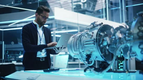 Engineer with Laptop Developing Turbine Engine Video stock 229844305