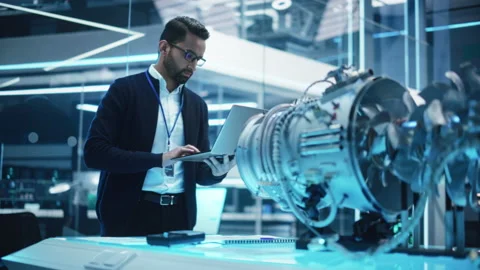 Engineer with Laptop Developing Turbine Engine Stock Footage 229844401