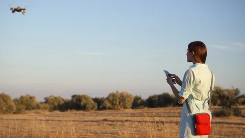 Engineer launch hand-made drone. Professional female manage flying quadcopter Stock Footage 107341613