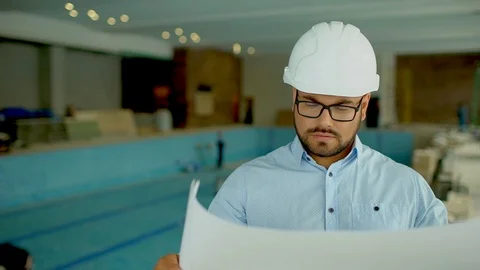Engineer looking at building plans in construction site. Stock Footage 86959042