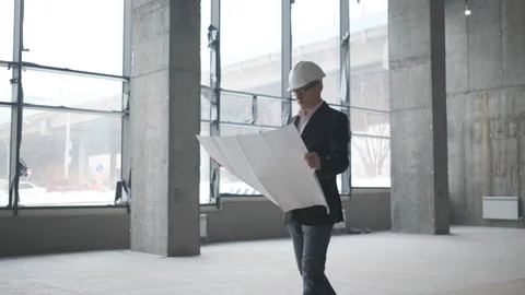 Engineer Looking At Building Plans In Construction Site. Stock Footage 106992394