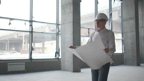 Engineer Looking At Building Plans In Construction Site. Stock Footage 106993118