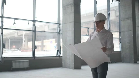 Engineer Looking At Building Plans In Construction Site. Stock Footage 107077163