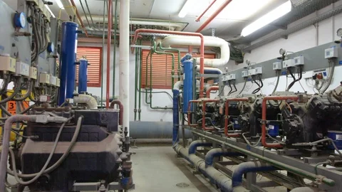 Engineer looking at the high pressure air compressor and writing. Video stock 103032115