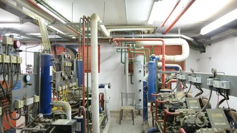 Engineer looking at the high pressure air compressor and writing.	 스톡 동영상 103868630