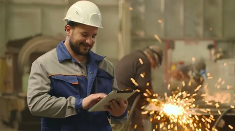 Engineer looks at camera, smile and shows his hand with thumb up in heavy Stock-Footage 65251671
