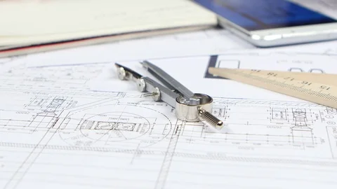 Engineer looks at the data for the drawing in the phone and writes them down Stock Footage 73682964