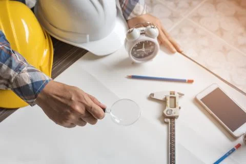 Engineer with magnify glass for looking blank paper for new project. Engine.. Stock Photos
