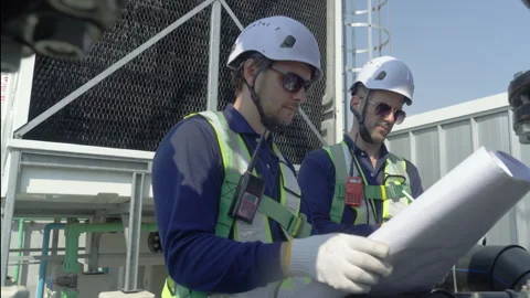 Engineer maintenance hvac cooling tower inspection rooftop helmet blueprint.. Stock Footage 335192276