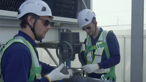Engineer maintenance hvac cooling tower technician safety helmet guide repa.. Stock Footage 335193850