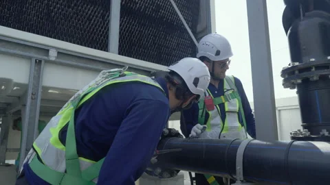 Engineer maintenance hvac cooling tower inspection valve pipe safety helmet.. Stock Footage 335193957