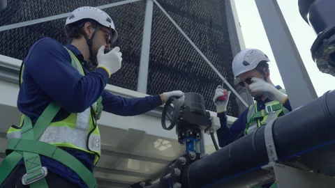Engineer maintenance hvac cooling tower technician safety helmet pipeline o.. Stock Footage 335194148