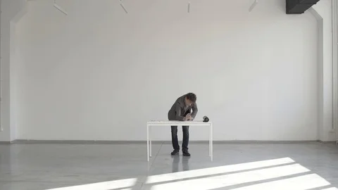 Engineer makes a drawing at a white table in the room Stock Footage 124941319