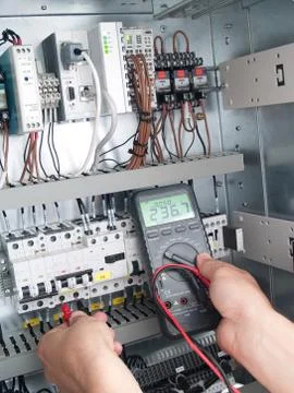 Engineer makes maintenance of power network automation Stock Photos