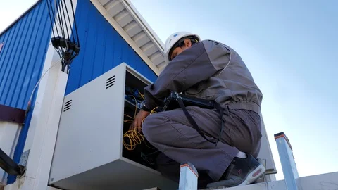 A engineer makes repairs in the technical box of the Internet provider Stock-Footage 127977597