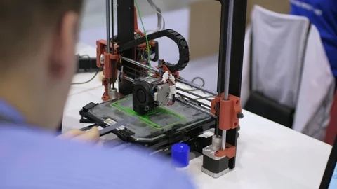 Engineer male looking at 3d printer at work. 3D printing manufacture concept. Stock Footage 94772568