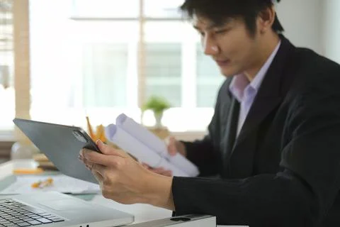 Engineer male using digital tablet and working in office for architectural pl Foto stock