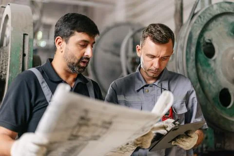 Engineer male workers team working service maintenance machine looking at b.. Stock Photos