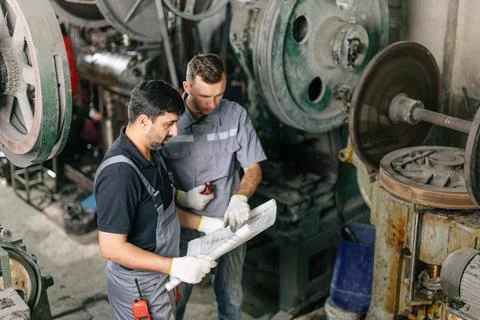 Engineer male workers team working together service maintenance machine in .. Stock Photos