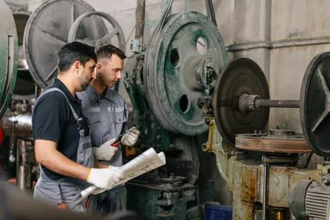 Engineer male workers team working together service maintenance machine in .. Stock Photos