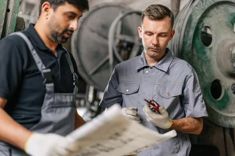 Engineer male workers team working together service maintenance machine in .. Stock Photos
