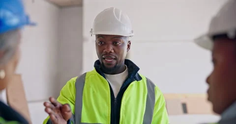 Engineer, man and discussion at construction site with team, advice and Stock Footage 345300340