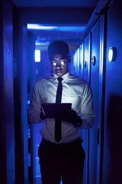 Engineer, man and reading tablet in server room for maintenance, software u.. Stock Photos