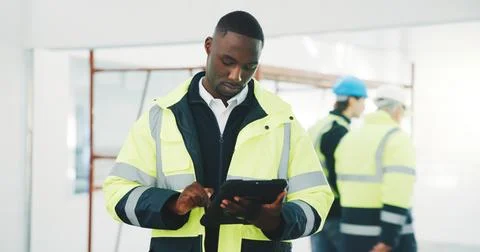 Engineer, man and scroll at construction site with tablet, app and AI software 写真素材