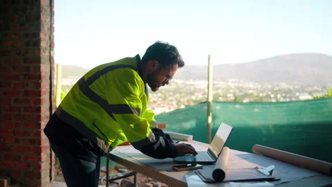 Engineer, man and typing on construction site with laptop, planning or research Stock Footage 336202772