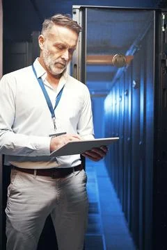 Engineer, man and typing on tablet in server room for maintenance, diagnostics Stock Photos
