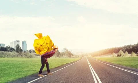 Engineer man carry load Builder man carrying paper ball on his back ,model... 库存照片