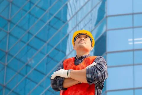 Engineer man checking and planning project at construction site, Man looking sky 写真素材