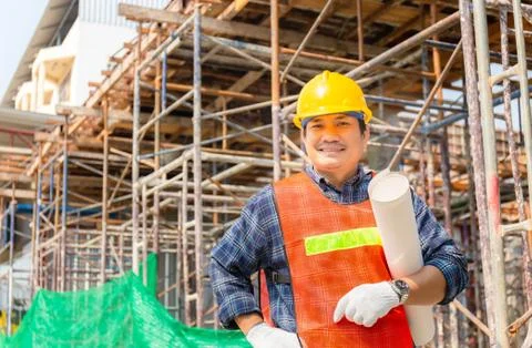 Engineer man checking and planning project at construction site, Smiling man Фото