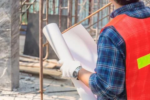 Engineer man checking and planning project at construction site Stockfoto's