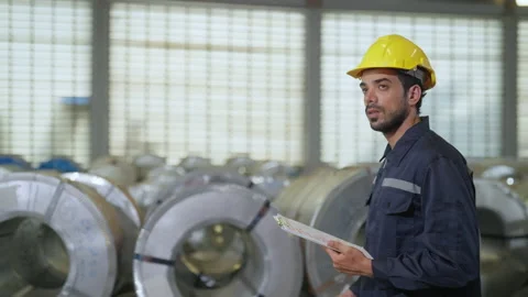 Engineer man examining and measuring steel at lathe factory. Stock Footage 228854233