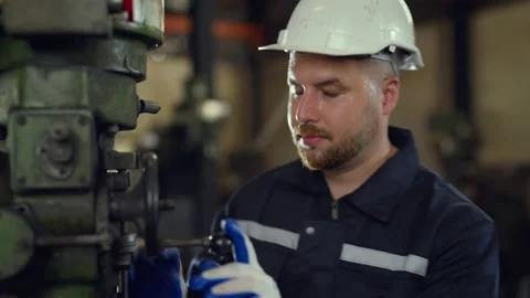 Engineer man examining and measuring steel at lathe factory. Stock Footage 228861905