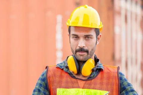 Engineer man in hard hat and safety vest, worker at construction site 写真素材