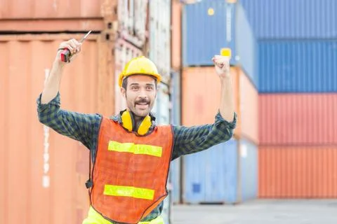 Engineer man in hard hat celebrating victory, foreman worker raise hands in c Fotos Stock