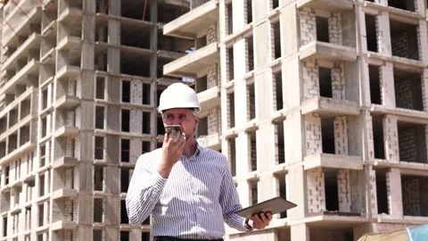 Engineer man in helmet use tablet computer for controls construction Stock Footage 340068072